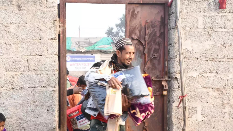 Refugee families leaving our winter relief distribution