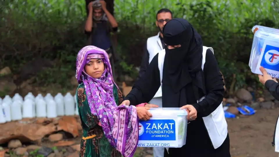 A village girl receives a hygiene kit for her family