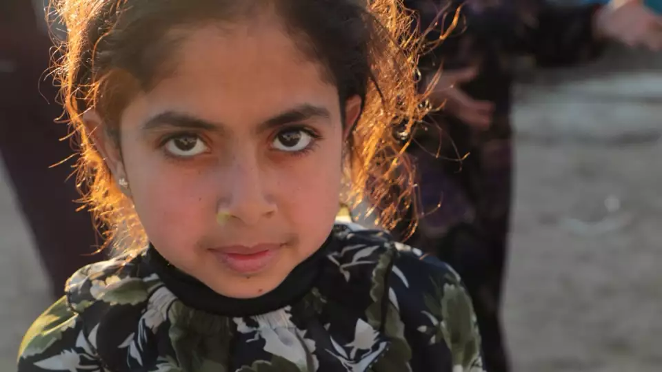 A young girl in Lebanon is provided a warm, hearty and filling Ramadan celebration meal