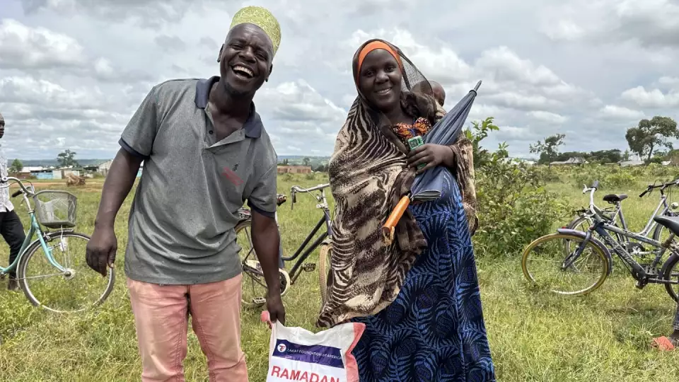 Smiles all around as relief sets in with a food package for this family.