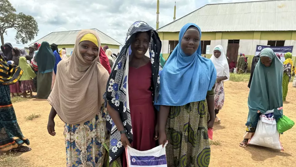 Girls in Tanzania come to our food distribution for packages that will help their families.
