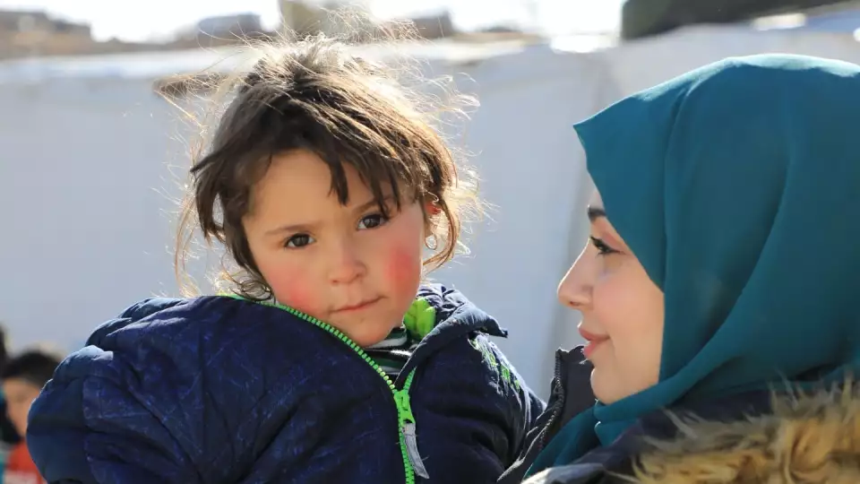 There are many refugees in Lebanon who are housed in temporary tents and dwellings. Here a Zakat Foundation of America worker brings cuddles and love to a Lebanese girl