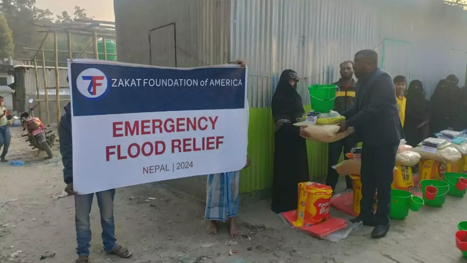 Food and emergency supplies are distributed to those displaced by the flooding in Nepal