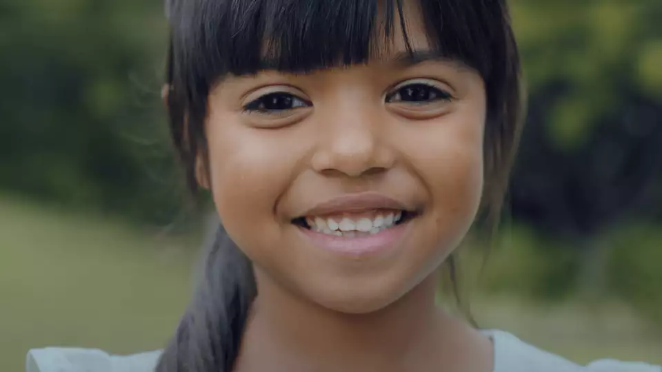 Image of young girl smiling in USA after getting help from Zakat Foundation