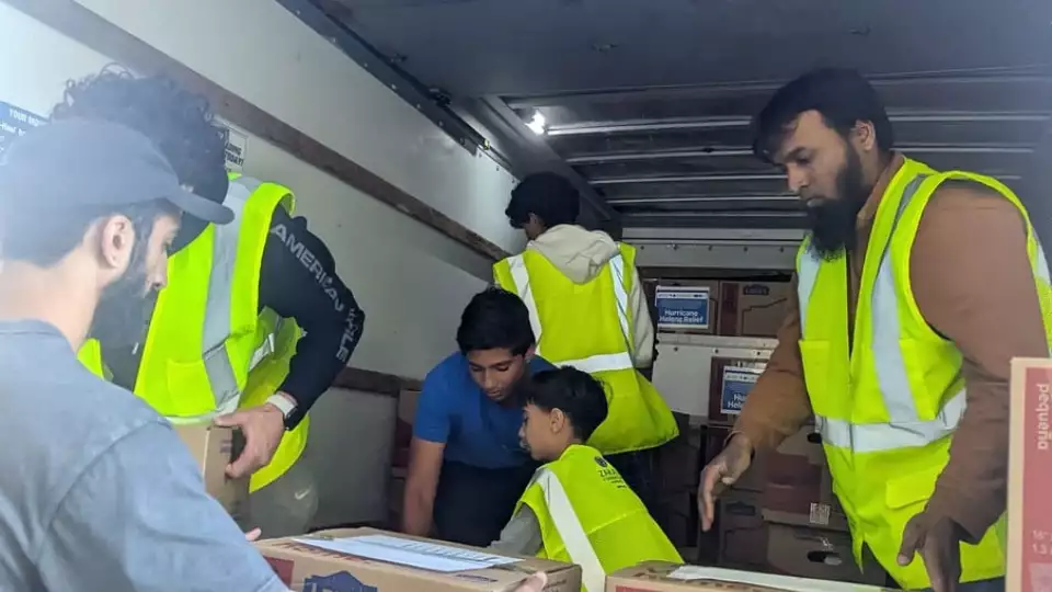 Boxes of hurricane relief supplies being unloaded by volunteers