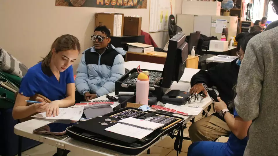 Eye exams being done for families at the Rohingya Cultural Center