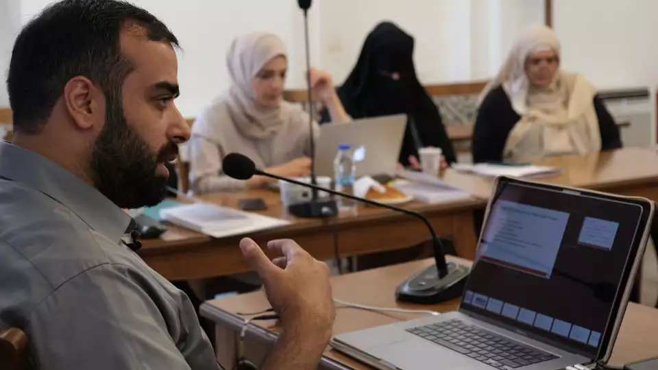 Students at Khalil Center take notes during a class targeting mental health services