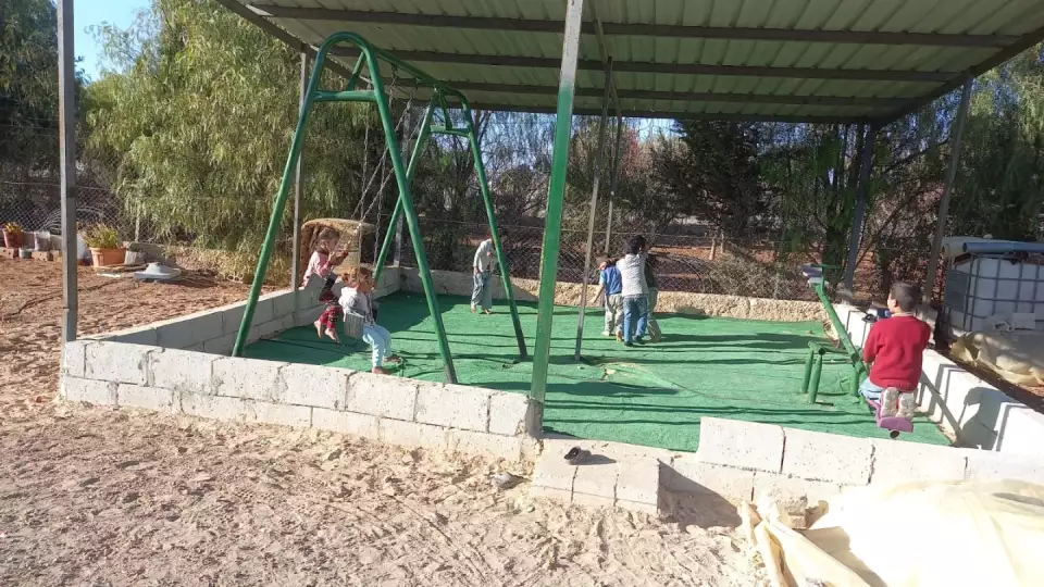 Refugee children in Jordan enjoy a break during classes in their caravan shelter schools.
