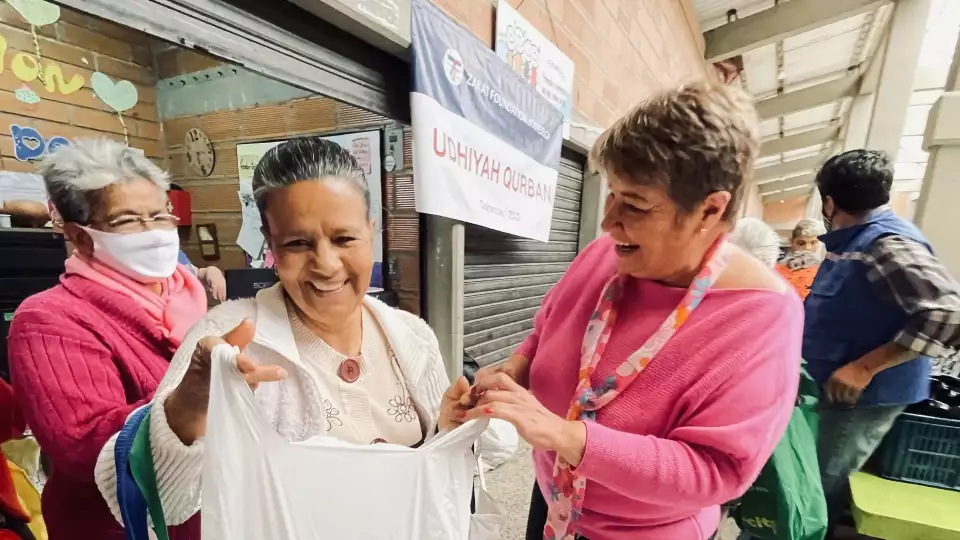 Smiles all around as Udhiyah-Qurbani meat distribution is received by needy families in Colombia.