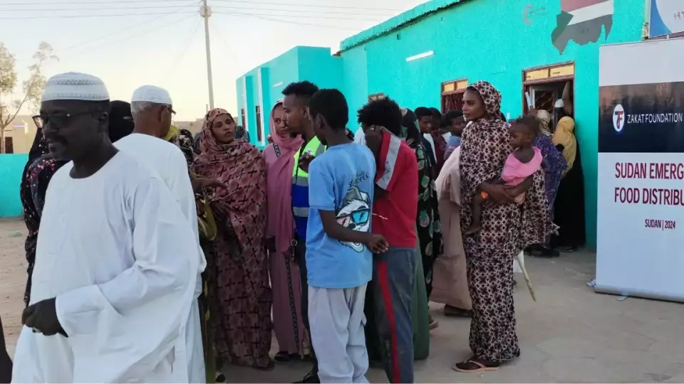 Sudanese families gather to receive food packages to help nourish their families during the civil unrest.