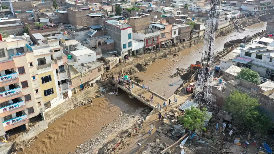 Our team crosses over flood waters with essentials for Pakistan flood affected families.