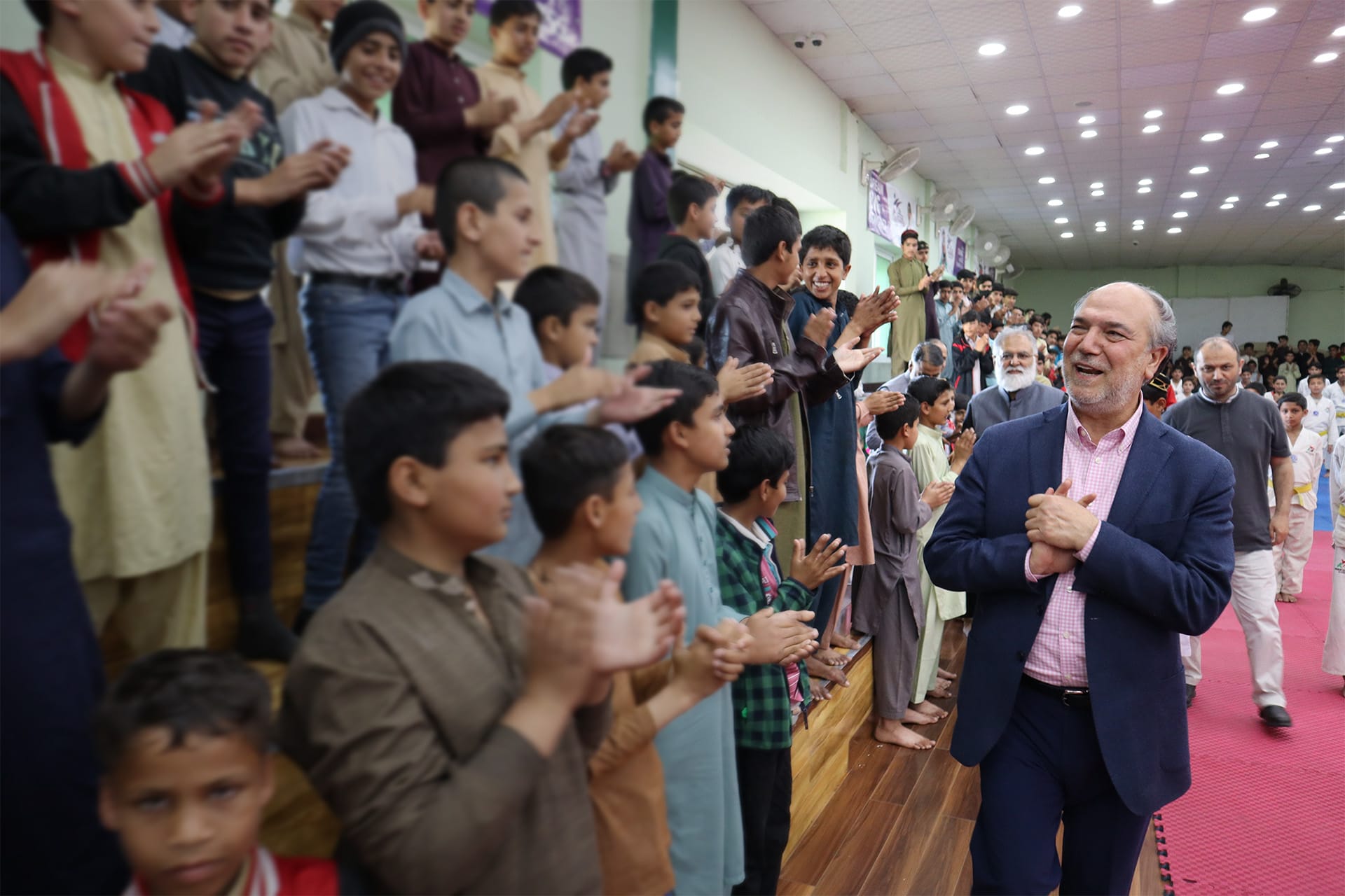 A picture of Halil Demir in front of a group of people.