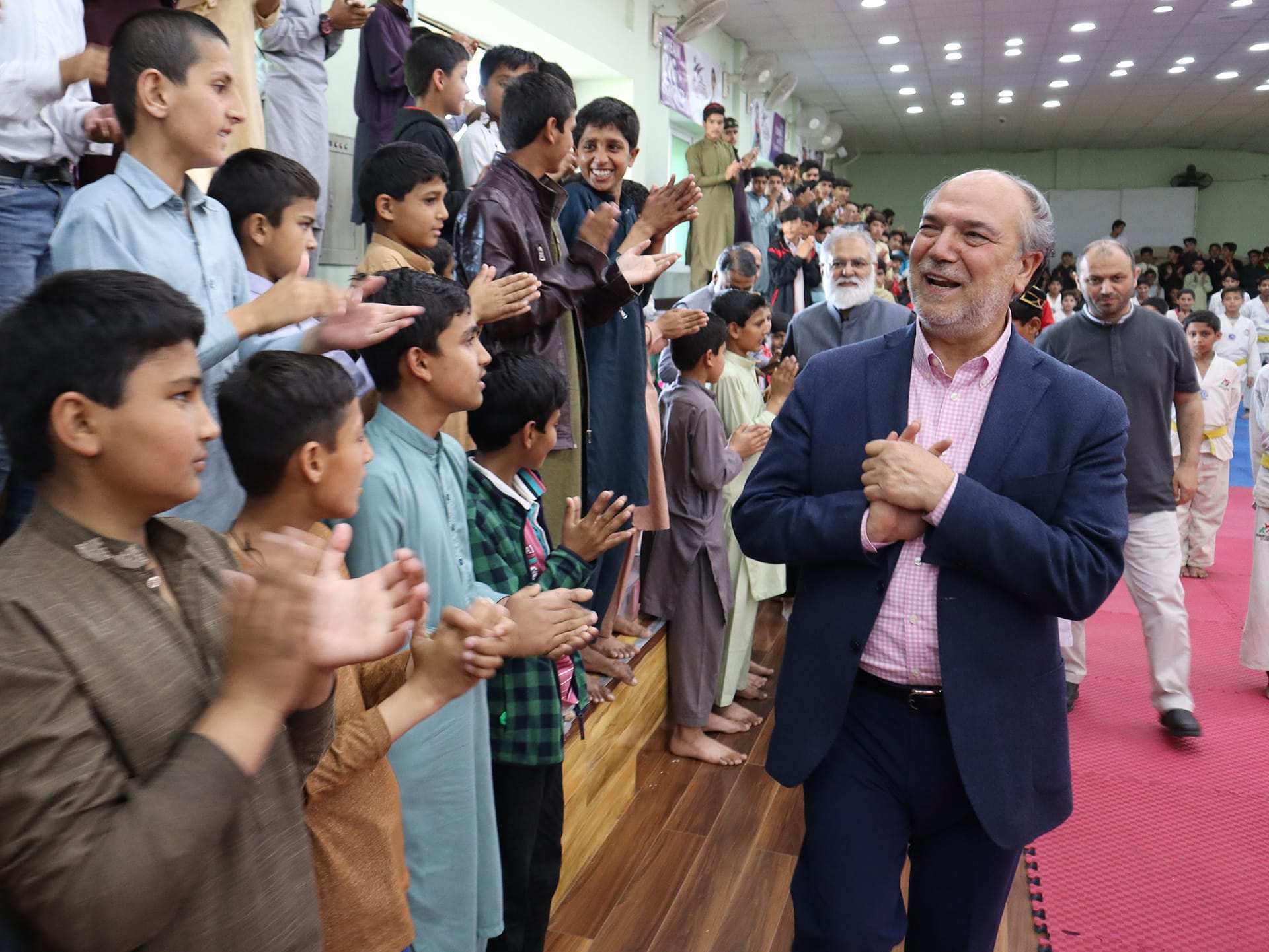 A picture of Halil Demir in front of a group of people.